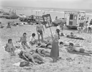 Женщина протестует против ношения бикини, держа табличку с надписью «Ты направляешься в ад» в Дейтона-Бич, Флорида, 1981. Фото Кита Макмануса.