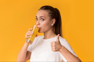 Женщина пьет из стакана 