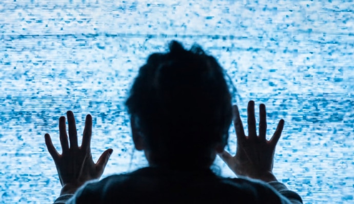 Жінка дивиться на зламаний телевізор